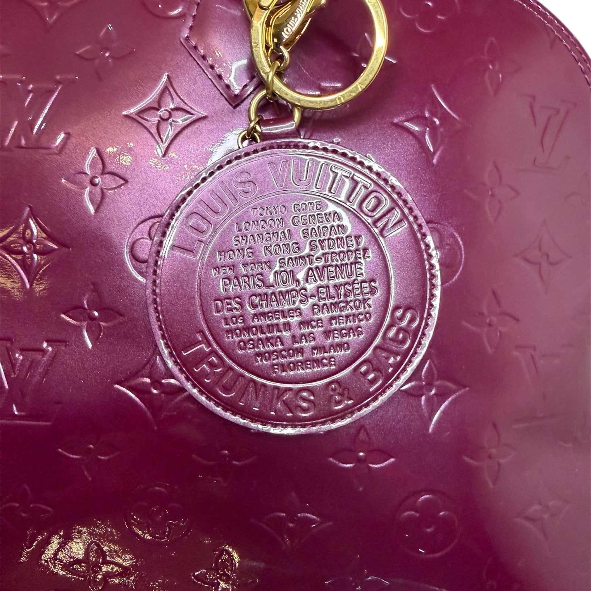 Louis Vuitton Alma MM in Vernis Amethyst from the Trunks & Bags collection, medallion view.