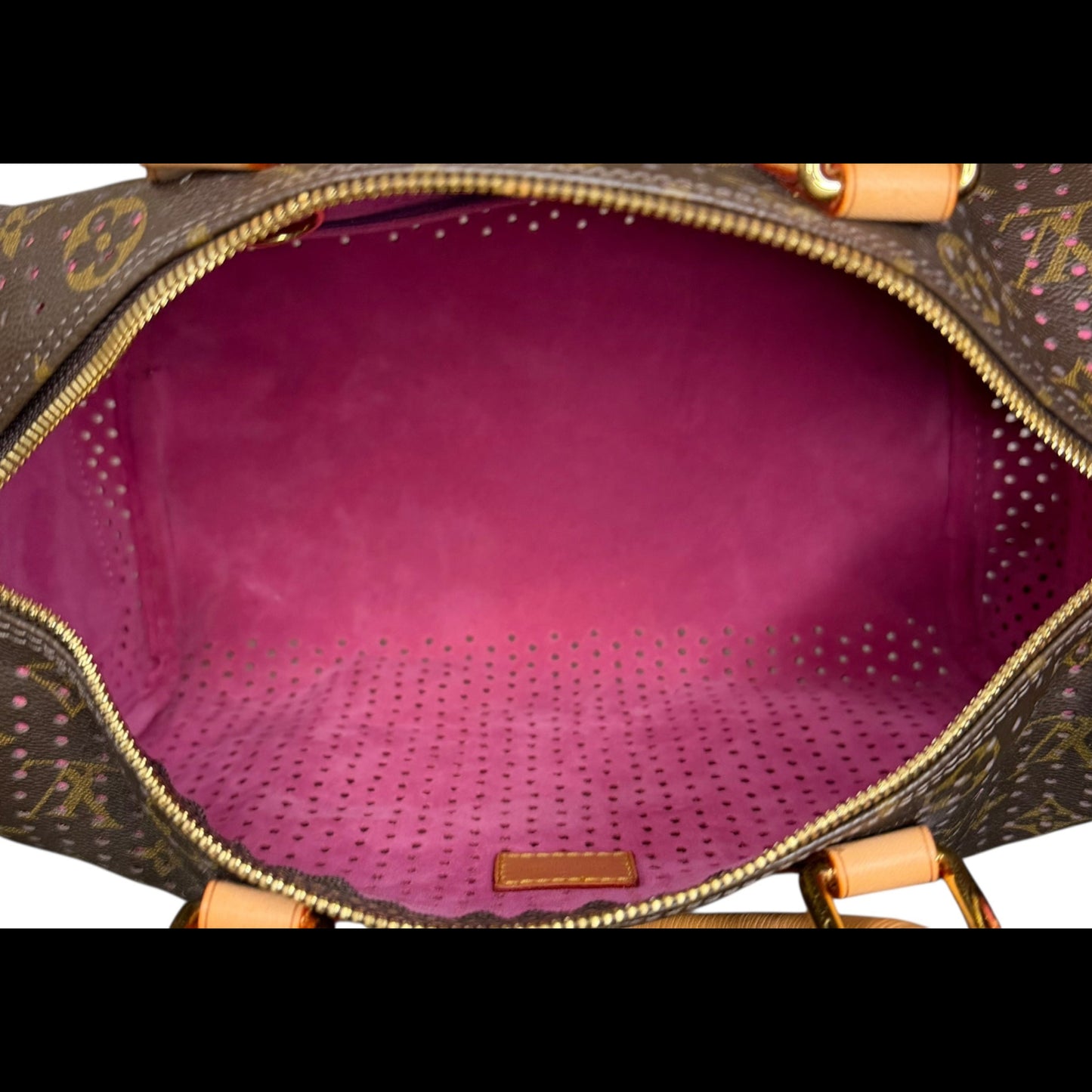 Louis Vuitton Speedy 30 in Monogram Perforated canvas with fuchsia underlay, interior view.