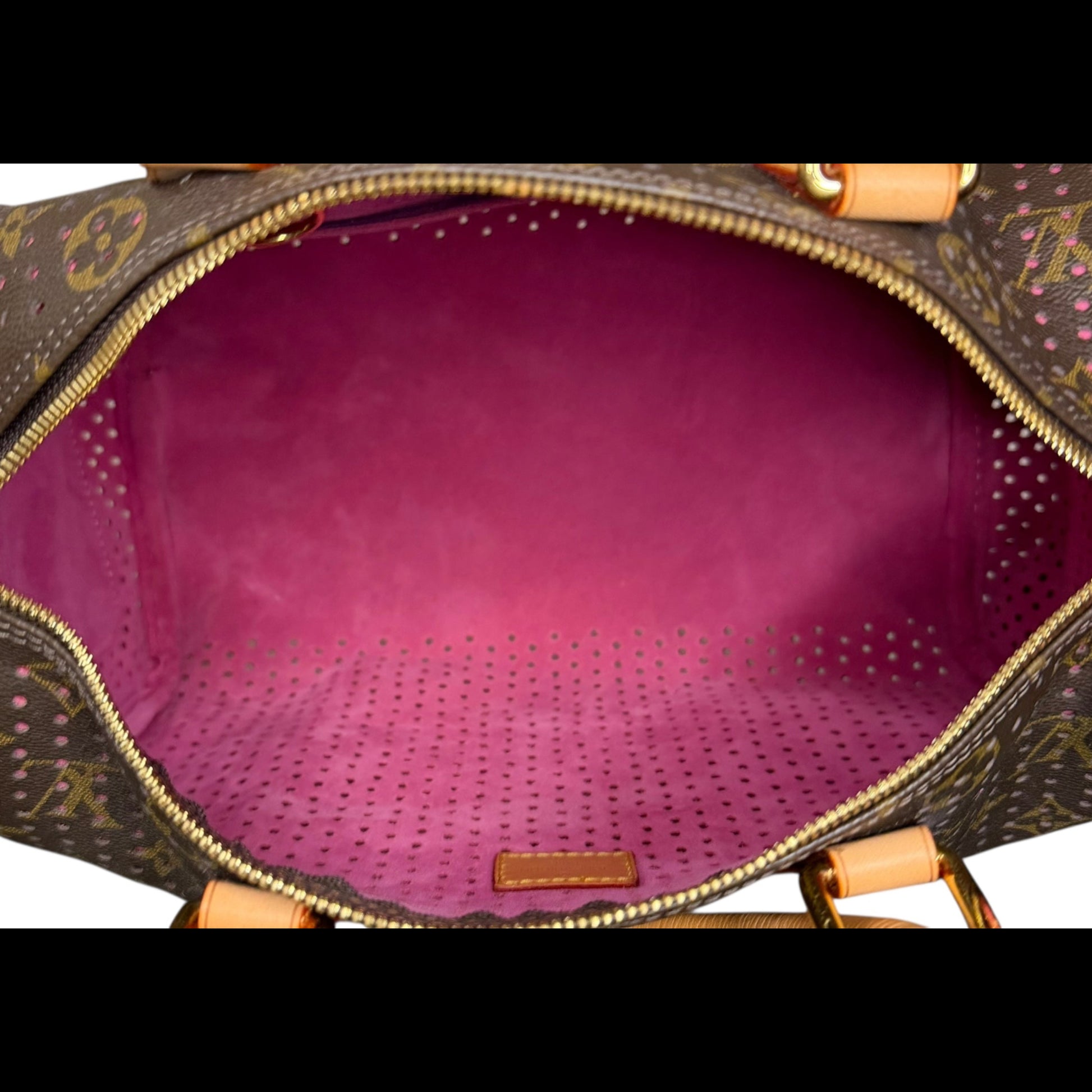 Louis Vuitton Speedy 30 in Monogram Perforated canvas with fuchsia underlay, interior view.